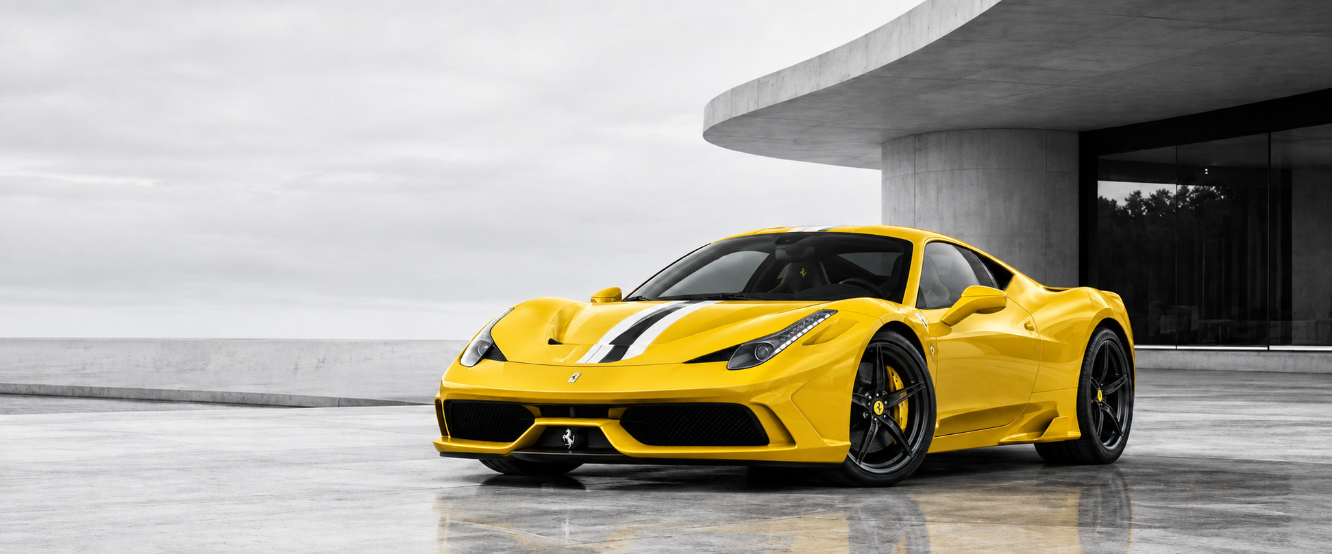A yellow Ferrari supercar parked in front of a modern concrete building